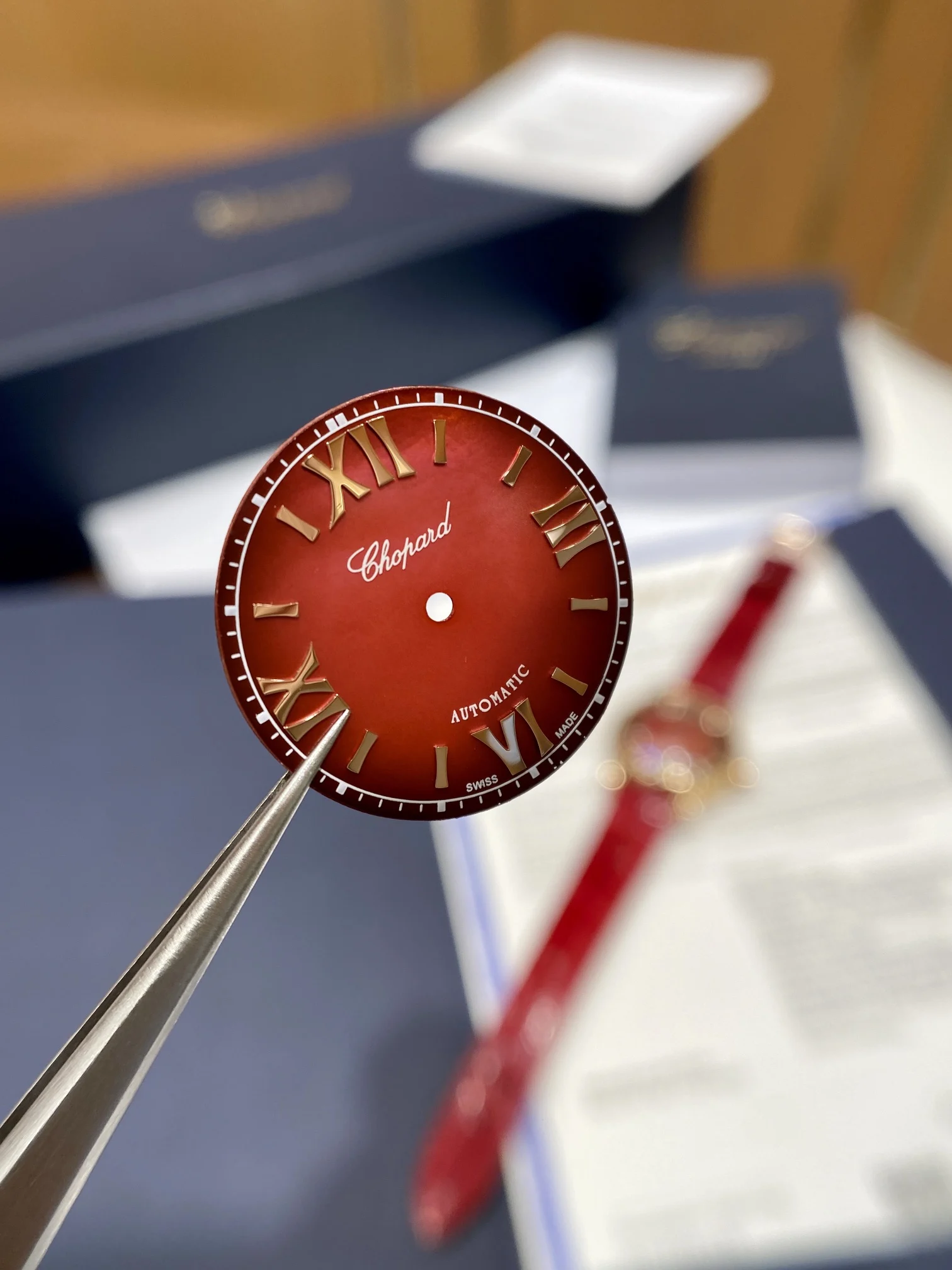The pomegranate red dial is absolutely gorgeous; it displays — photographed off the sweep