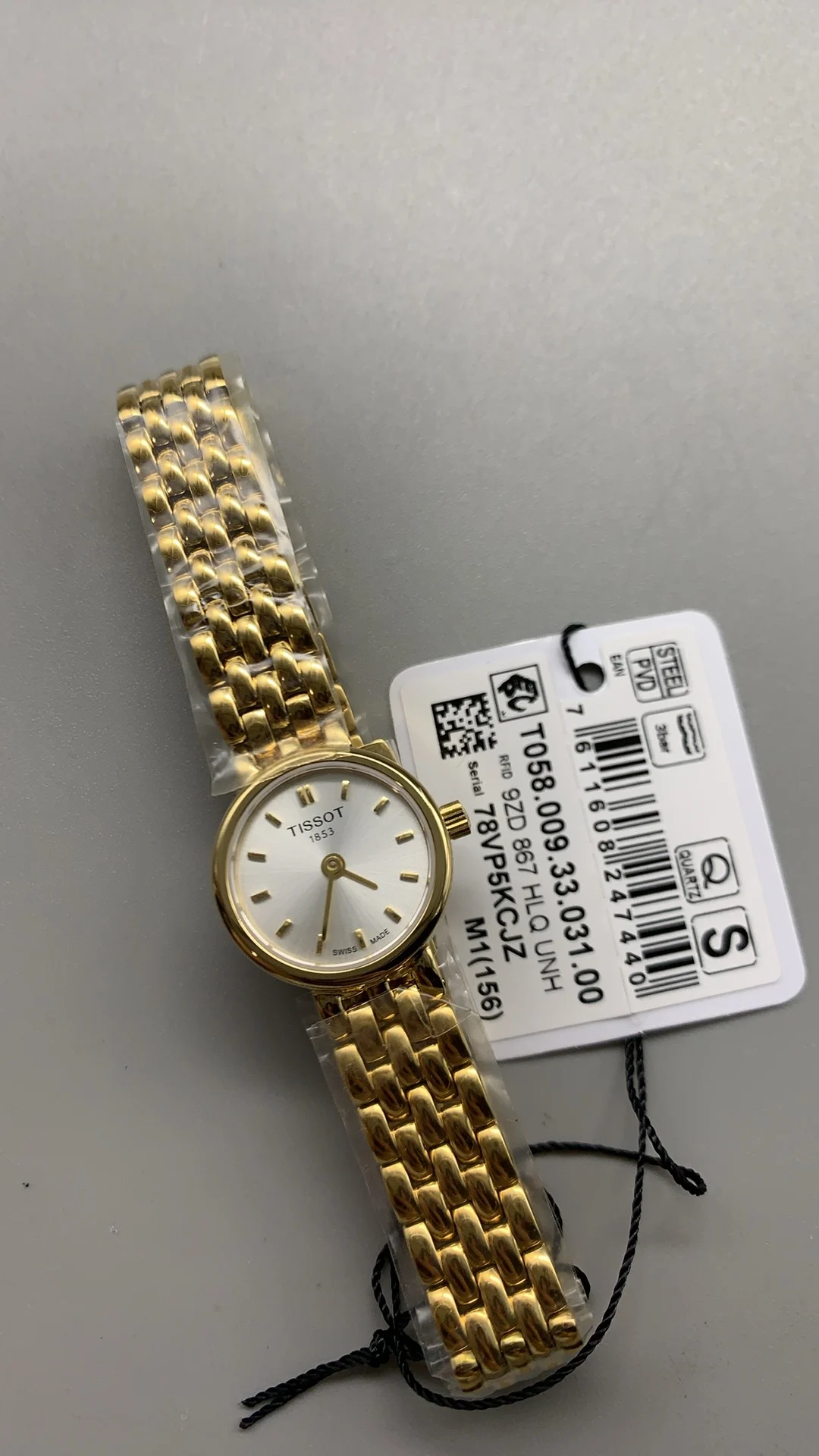 Tissot mini, gold — photographed off the sweep