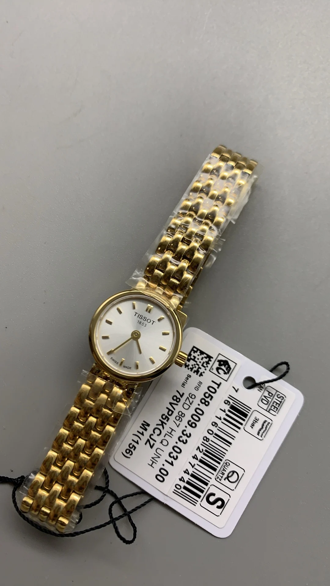 Tissot mini, gold — photographed off the sweep