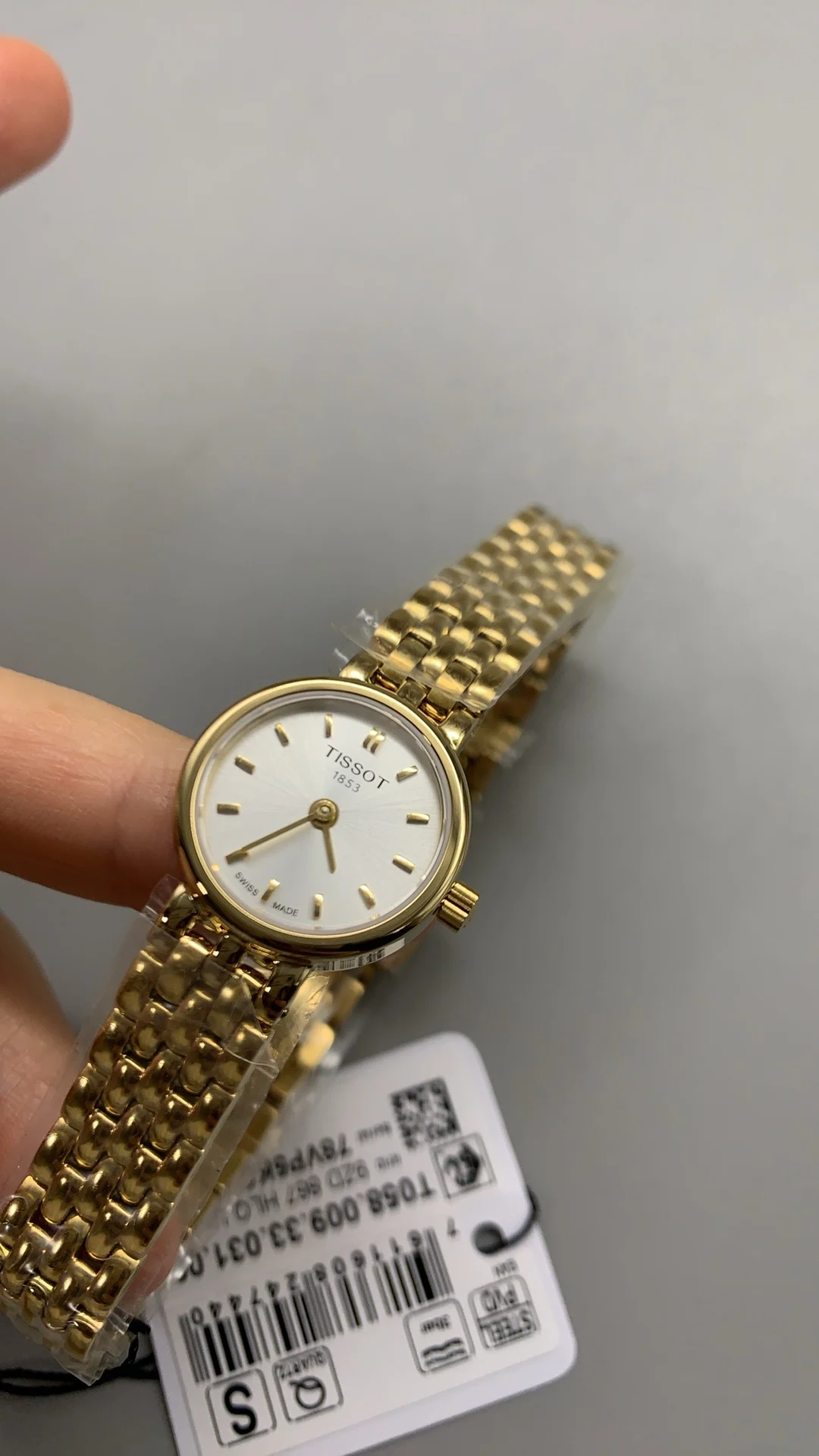 Tissot mini, gold — photographed off the sweep