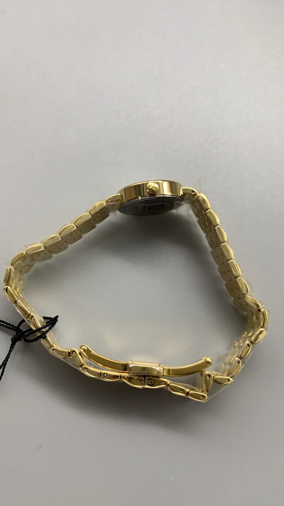 Tissot mini, gold — photographed off the sweep