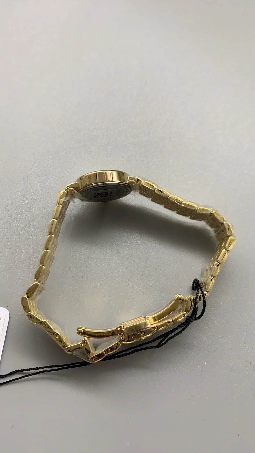 Tissot mini, gold — photographed off the sweep