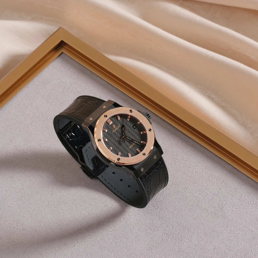 Two-tone steel and gold black carbon fiber — photographed off the sweep