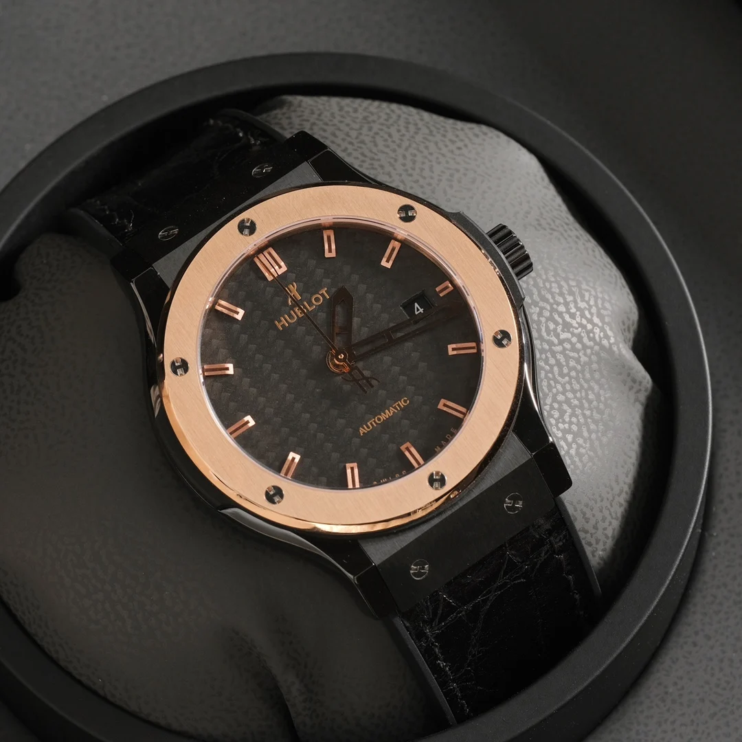 Two-tone steel and gold black carbon fiber — photographed off the sweep
