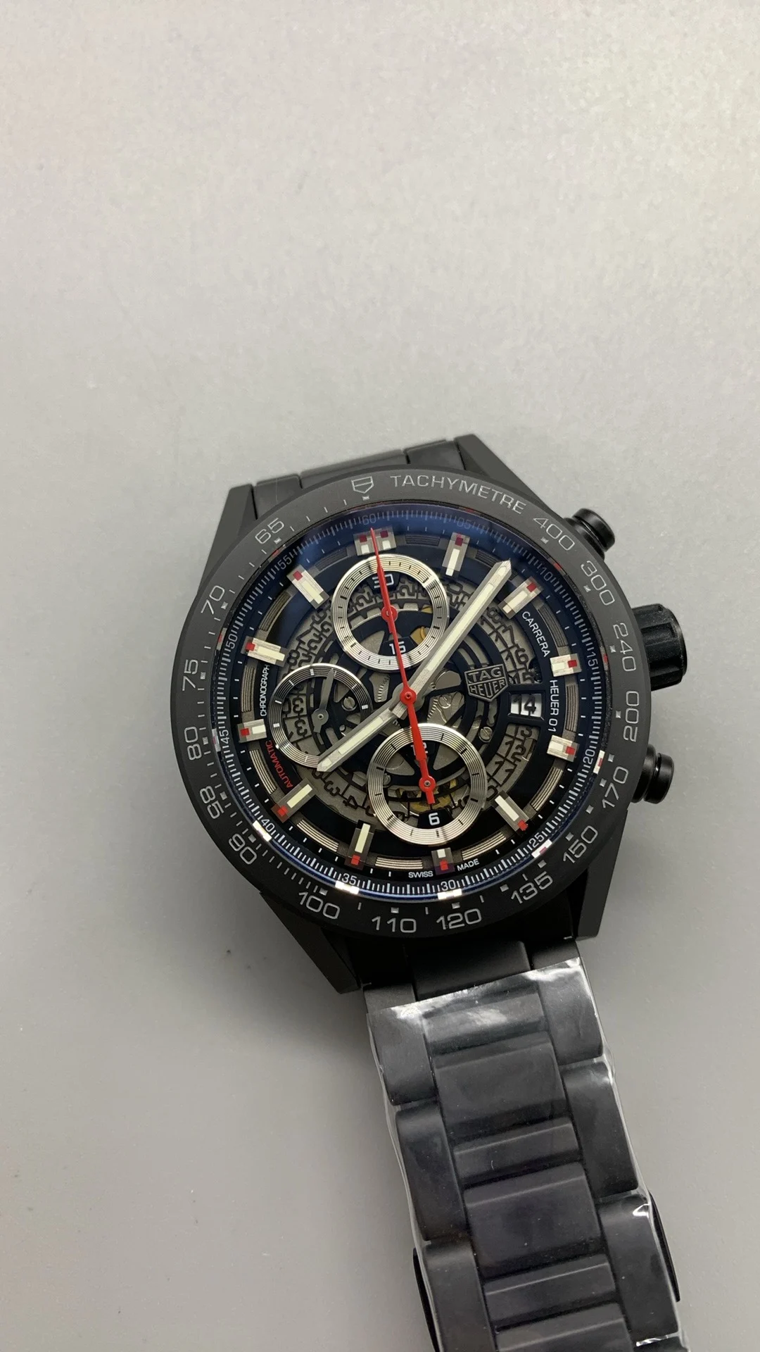 XF, all-black ceramic, tag, timing multifunction — photographed off the sweep