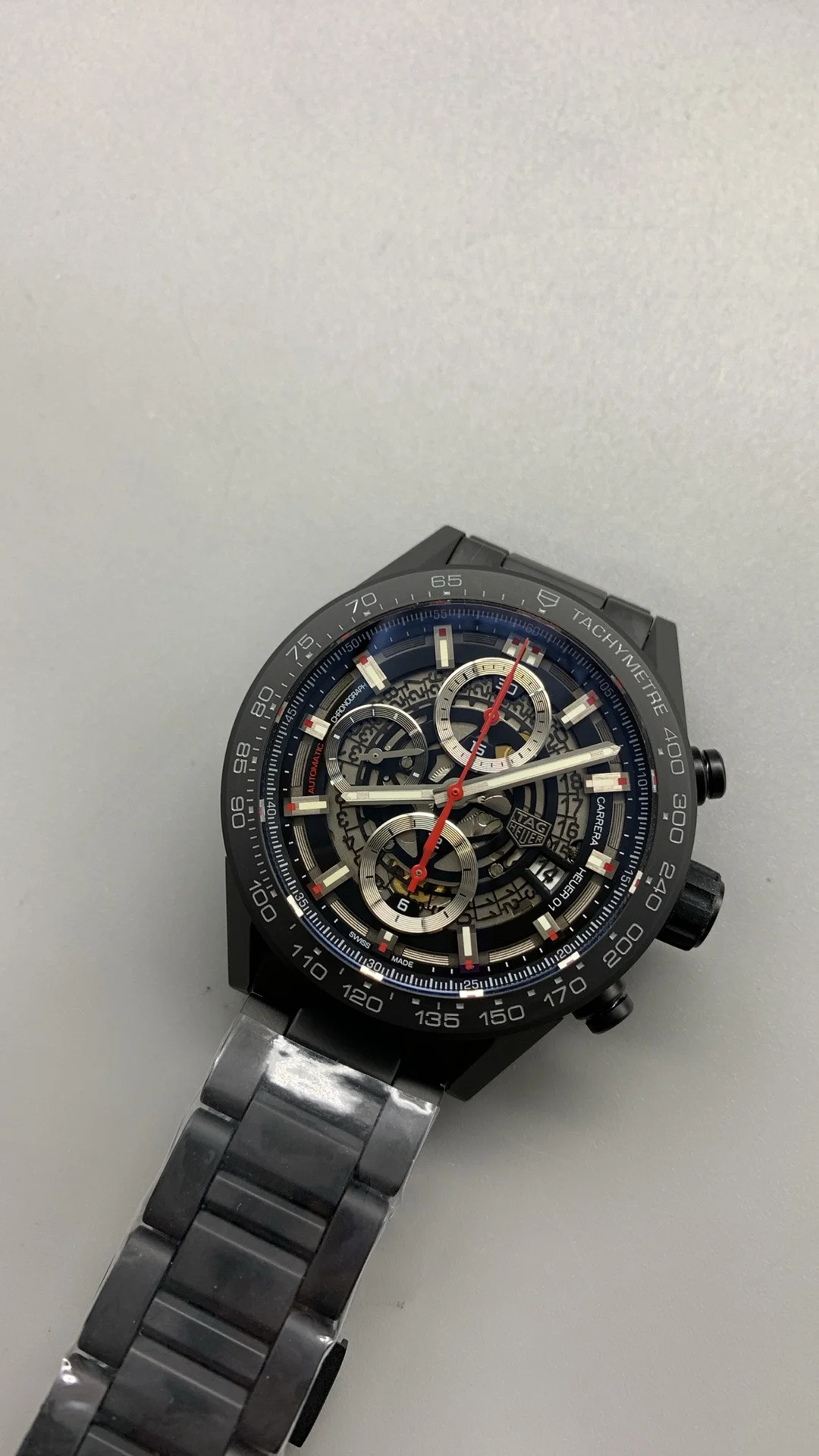 XF, all-black ceramic, tag, timing multifunction — photographed off the sweep