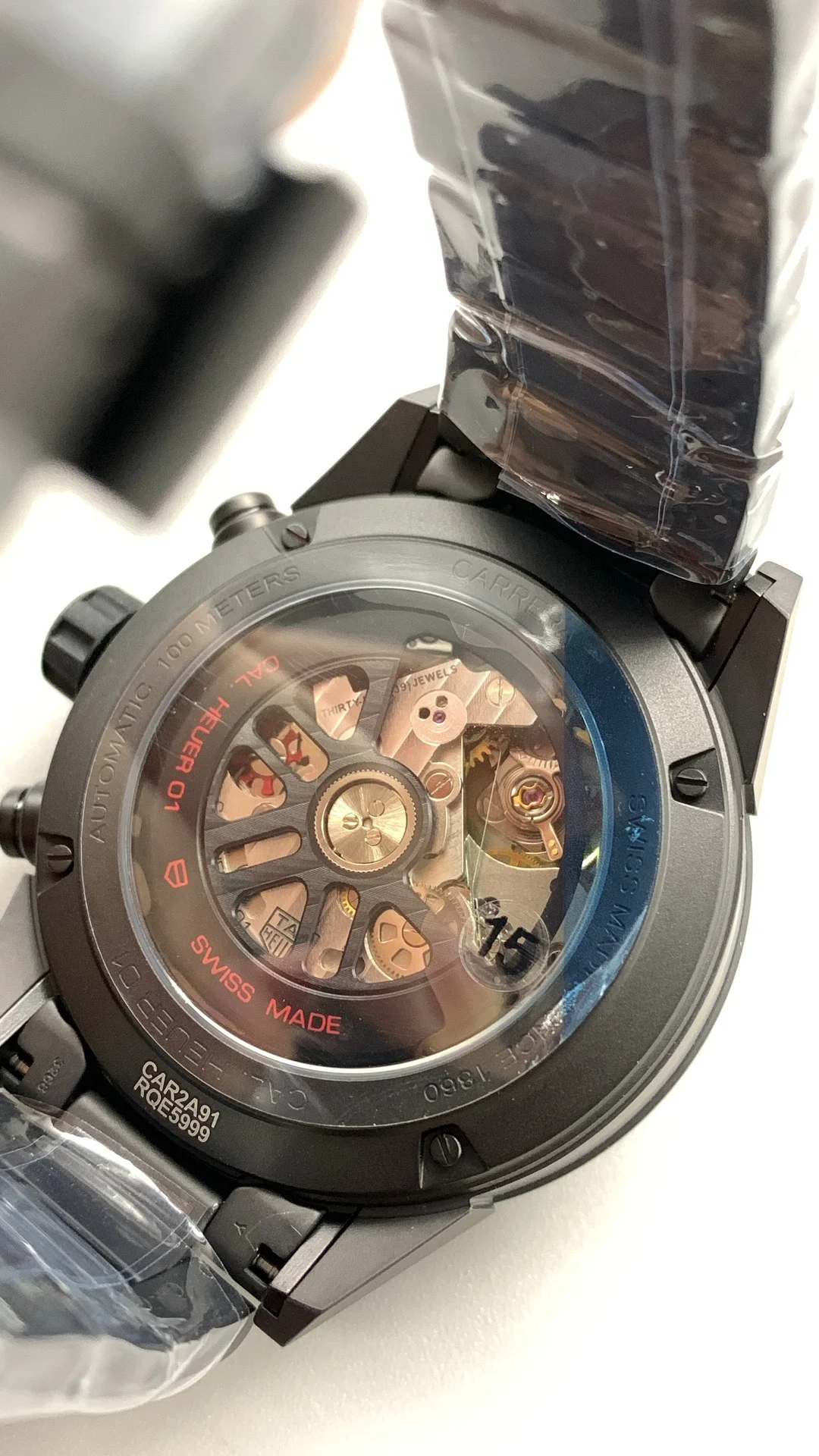 XF, all-black ceramic, tag, timing multifunction — photographed off the sweep